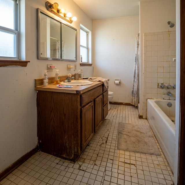 Bathroom in Tulsa OK with cracked tile and visible signs it needs remodeling