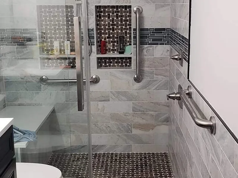 Modern walk-in shower remodel in Tulsa, OK featuring custom tile surround and frameless glass