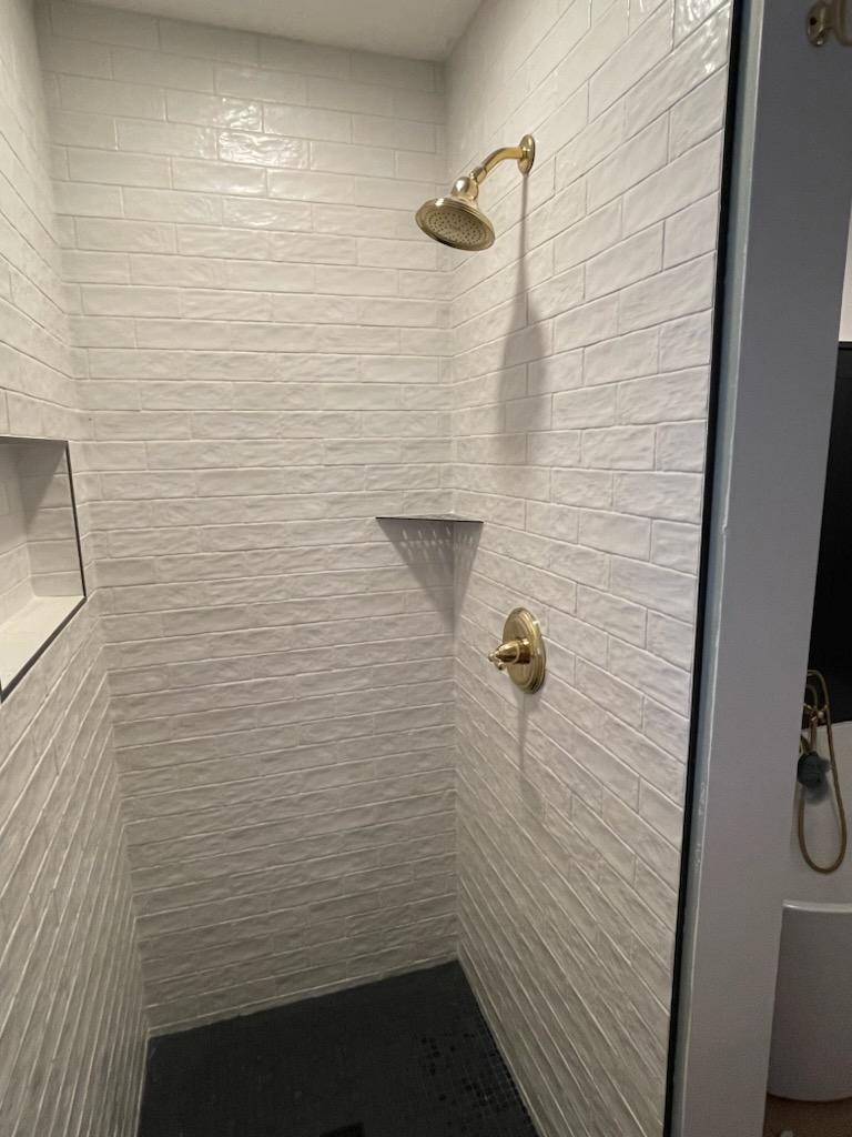Walk-in shower remodel in Tulsa with frameless glass and premium tile