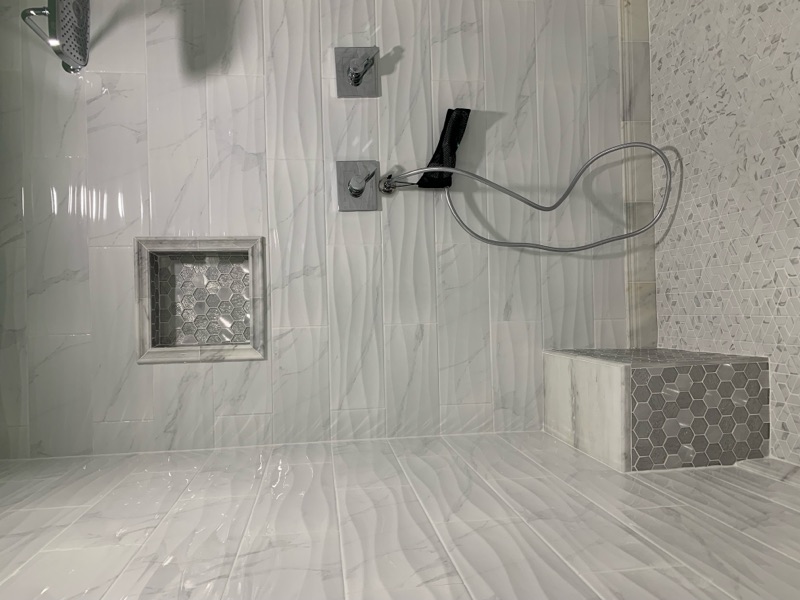 Walk-in shower with built-in tiled bench and hexagon niche storage detail